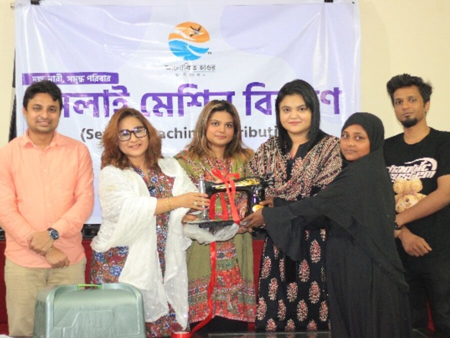 Sewing machines handed over to women at a distribution event